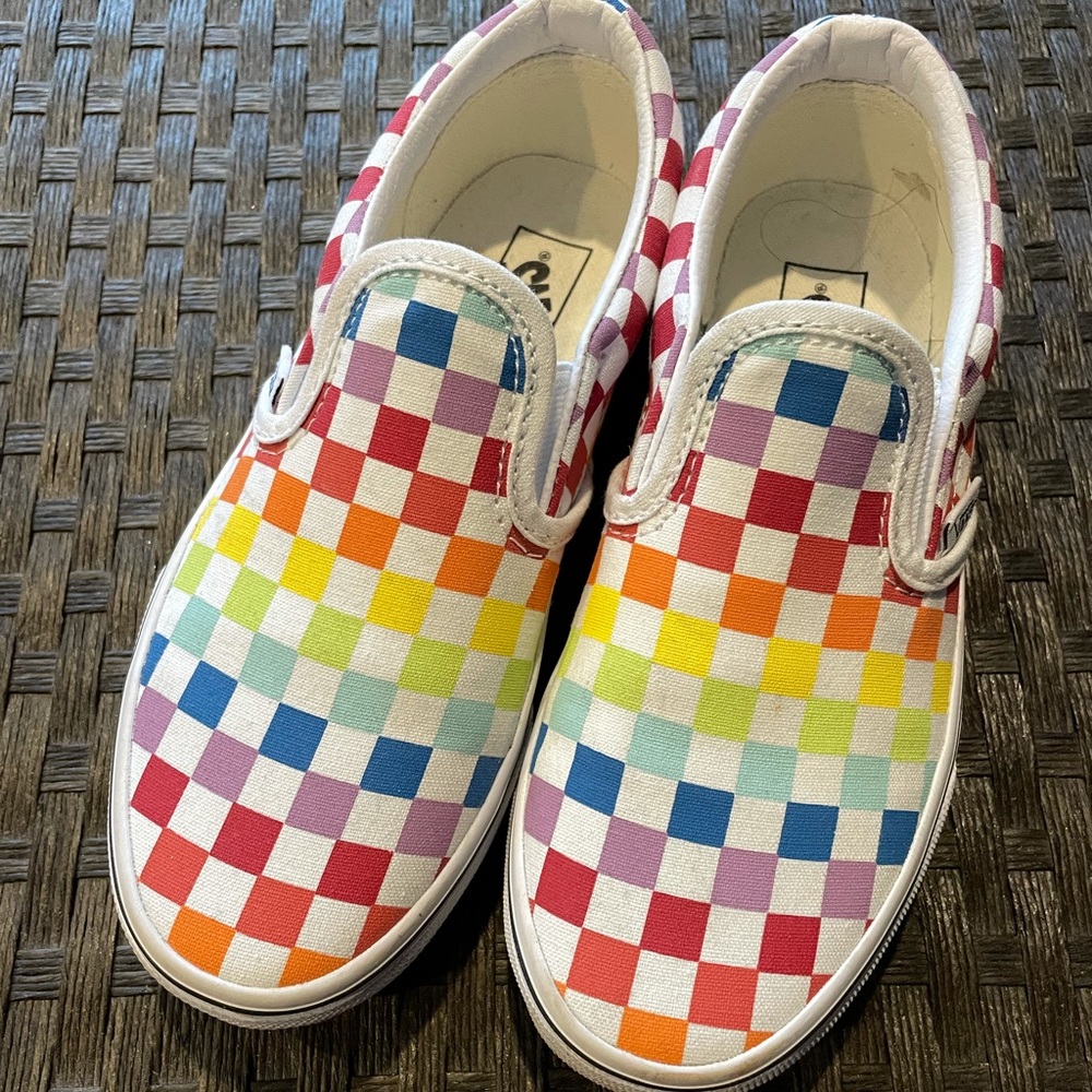 Girls Vans rainbow checker slip ons.